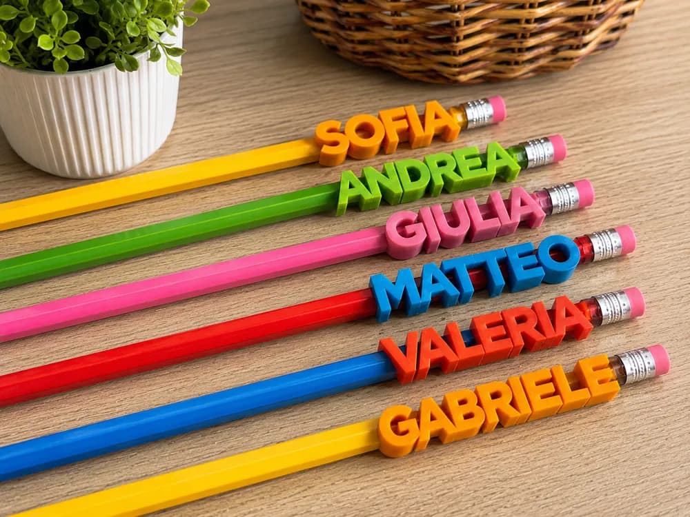 Personalized 3D printed name toppers on colorful pencils